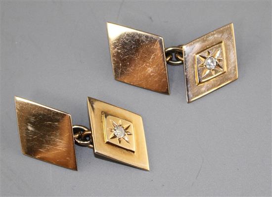 A pair of 9ct and diamond set diamond shaped cufflinks, length of one link 15mm, gross weight 7 grams.